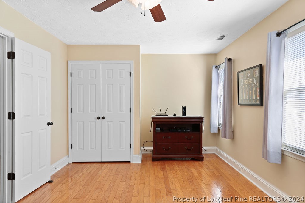 300 Shawcroft Road Fayetteville, NC 28311 - Photo 22 of 42 a view of an empty room with wooden floor and a window
