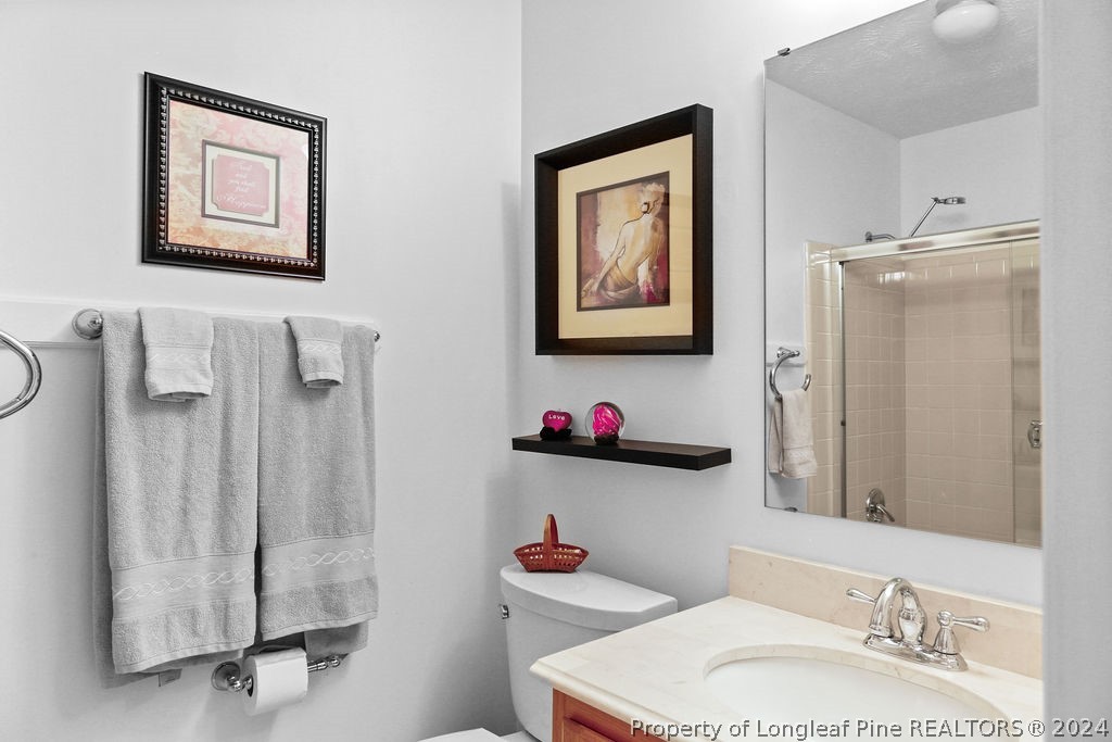 300 Shawcroft Road Fayetteville, NC 28311 - Photo 24 of 42 a bathroom with a sink mirror vanity and toilet