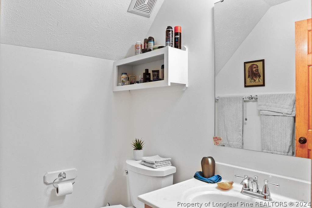 300 Shawcroft Road Fayetteville, NC 28311 - Photo 27 of 42 a bathroom with a sink and a mirror