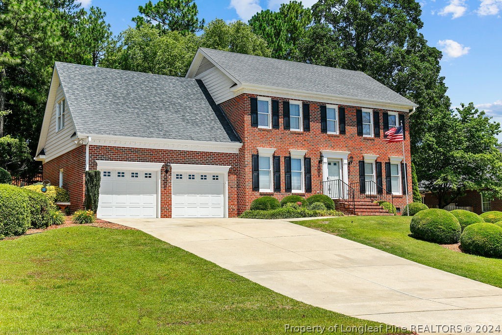 300 Shawcroft Road Fayetteville, NC 28311 - Photo 3 of 42 a front view of a house with a yard and garage