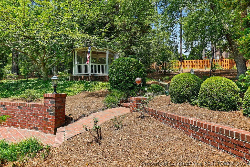300 Shawcroft Road Fayetteville, NC 28311 - Photo 35 of 42 a backyard of a house with a garden and plants