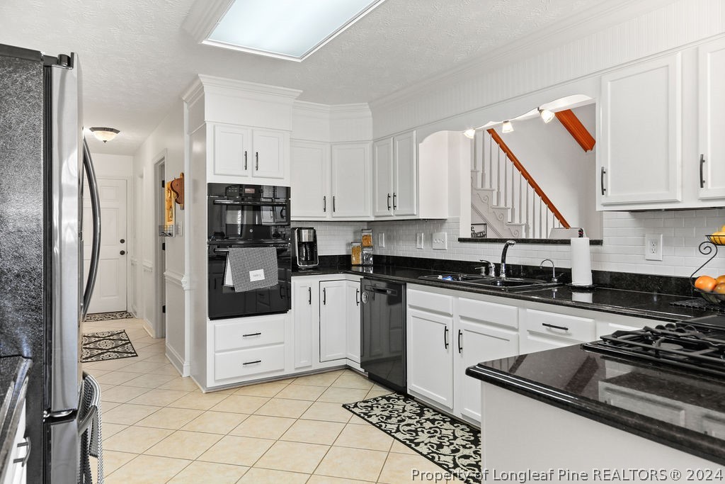 300 Shawcroft Road Fayetteville, NC 28311 - Photo 7 of 42 a kitchen with stainless steel appliances granite countertop a stove a refrigerator and a stove