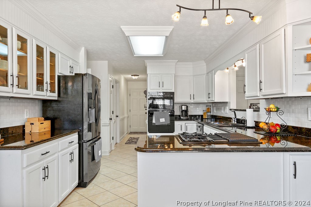 300 Shawcroft Road Fayetteville, NC 28311 - Photo 8 of 42 a kitchen with refrigerator and cabinets