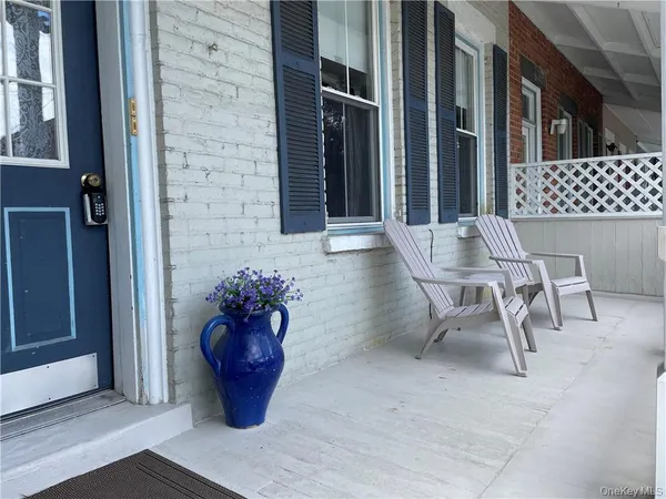 a view of a dinning tables and chairs in patio of a house