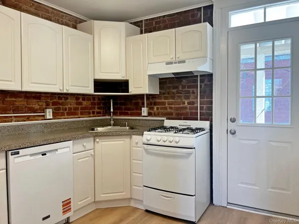 a kitchen with cabinets appliances and a sink