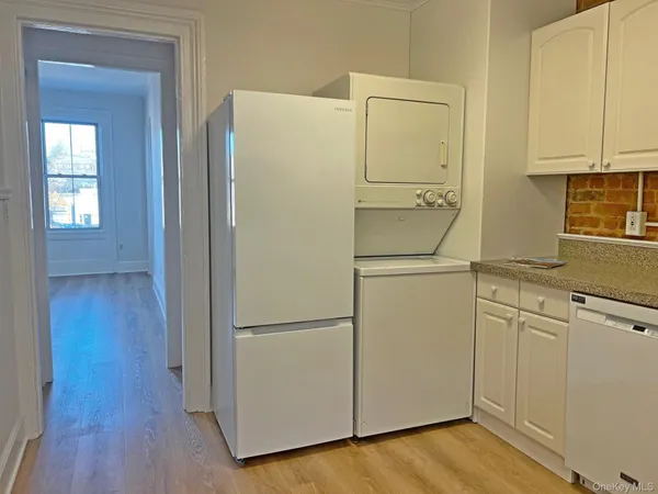 a white refrigerator freezer sitting in a kitchen