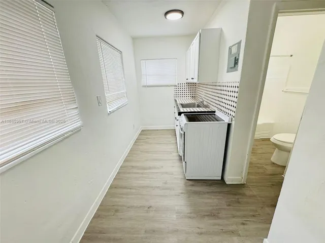 a kitchen with a sink a stove and cabinets