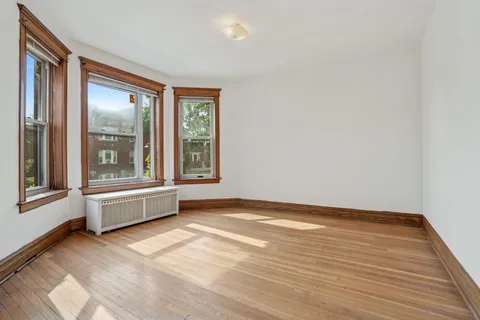 a view of an empty room with glass door