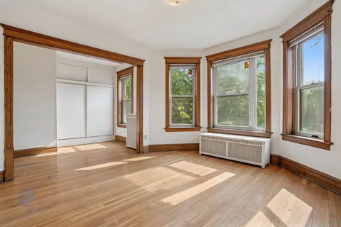 a view of an empty room with glass door and balcony