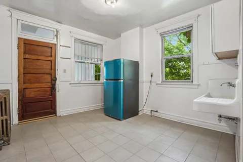 a view of kitchen with furniture and refrigerator