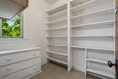 a view of walk in closet with empty racks