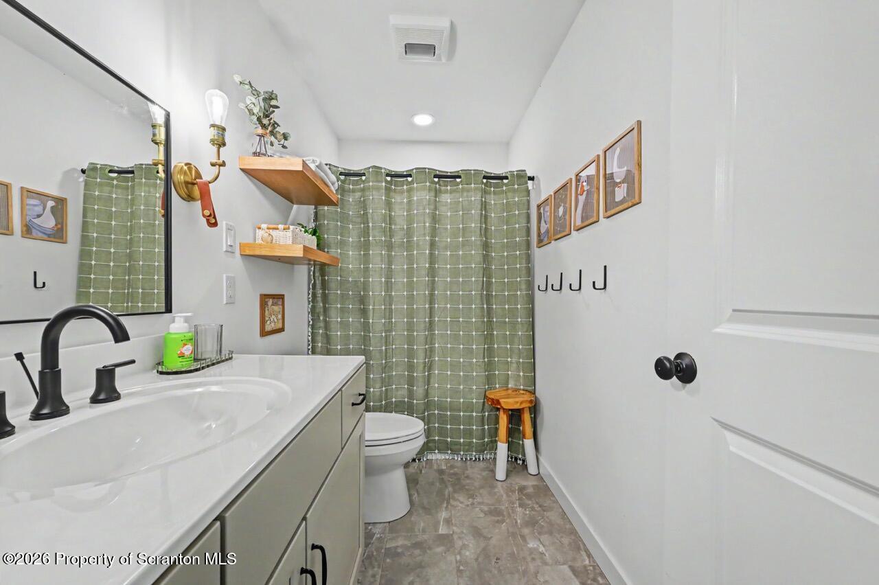 100 Highland Road Moscow, PA 18444 - Photo 72 of 85 a bathroom with a granite countertop sink a toilet and shower