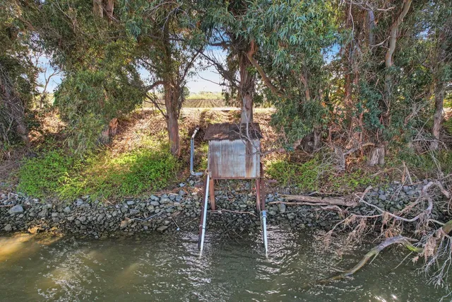 a stone house with a tree in the background