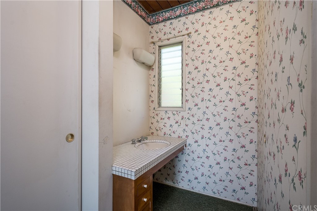 7214 Canyon Drive Whittier, CA 90602 - Photo 13 of 40 a bathroom with a sink and a mirror