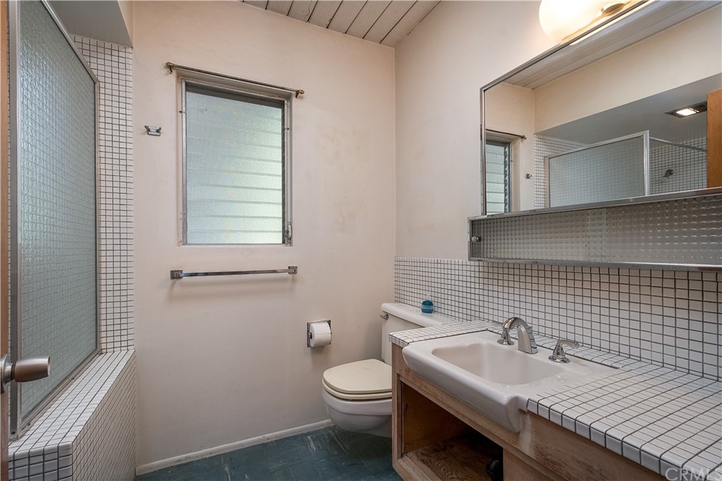 7214 Canyon Drive Whittier, CA 90602 - Photo 18 of 40 a bathroom with a sink toilet and mirror