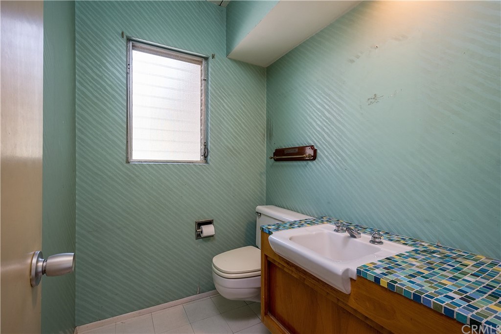 7214 Canyon Drive Whittier, CA 90602 - Photo 19 of 40 a bathroom with a sink toilet and window