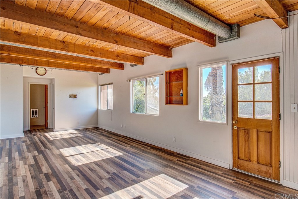 7214 Canyon Drive Whittier, CA 90602 - Photo 22 of 40 a view of an empty room with wooden floor and a window
