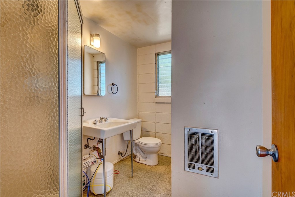 7214 Canyon Drive Whittier, CA 90602 - Photo 25 of 40 a bathroom with a sink toilet and a mirror