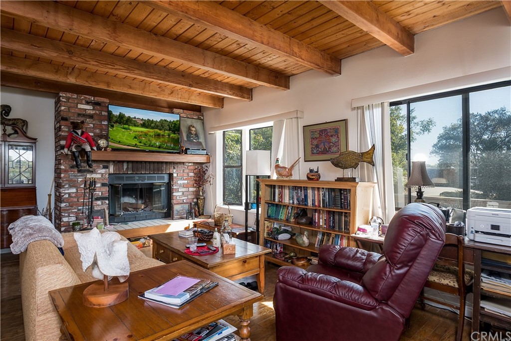7214 Canyon Drive Whittier, CA 90602 - Photo 29 of 40 a living room with furniture a fireplace and a flat screen tv