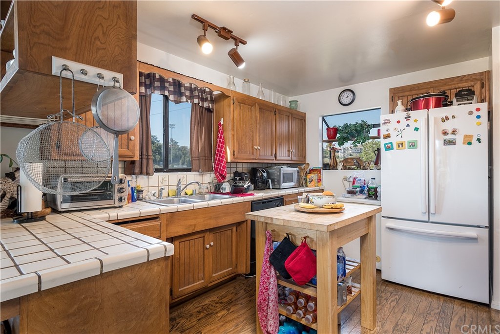 7214 Canyon Drive Whittier, CA 90602 - Photo 30 of 40 a kitchen with a sink stove and refrigerator