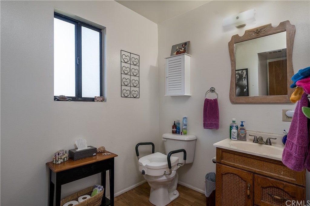 7214 Canyon Drive Whittier, CA 90602 - Photo 33 of 40 a bathroom with a toilet a sink and a mirror