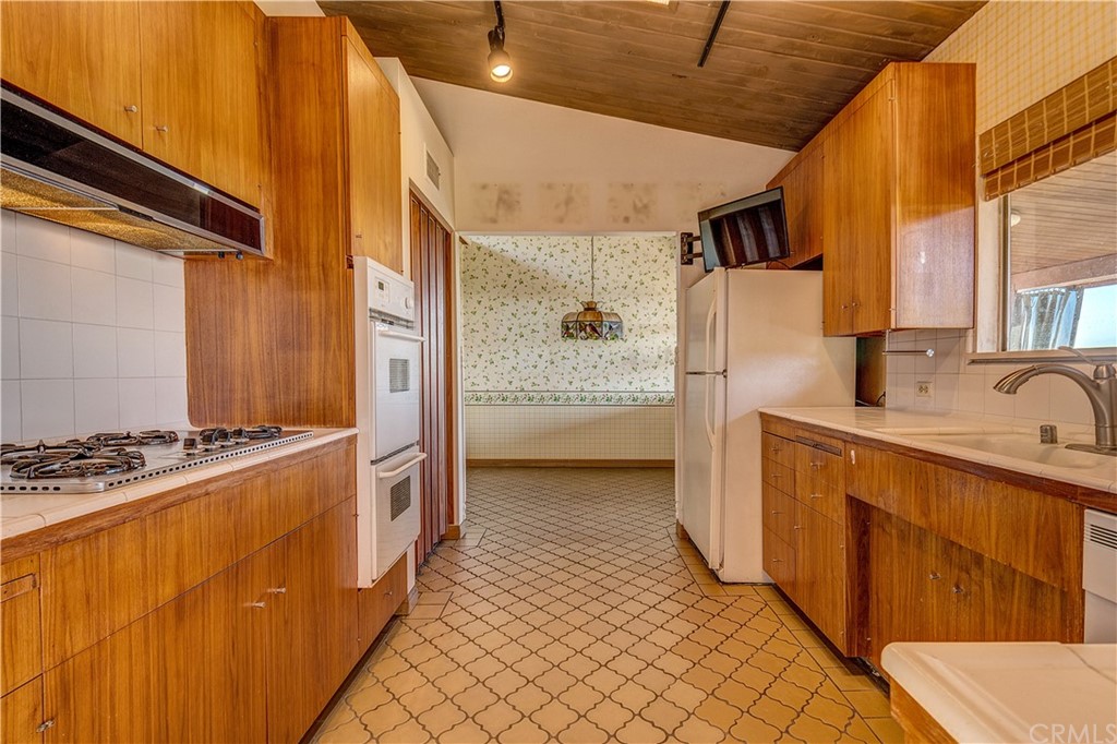 7214 Canyon Drive Whittier, CA 90602 - Photo 7 of 40 a kitchen with stainless steel appliances granite countertop a refrigerator and a stove