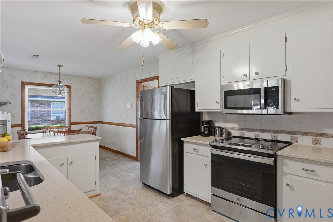 5210 Ronson Road North Chesterfield, VA 23234 - Photo 13 of 35 Kitchen featuring white cabinetry, light-toned cou