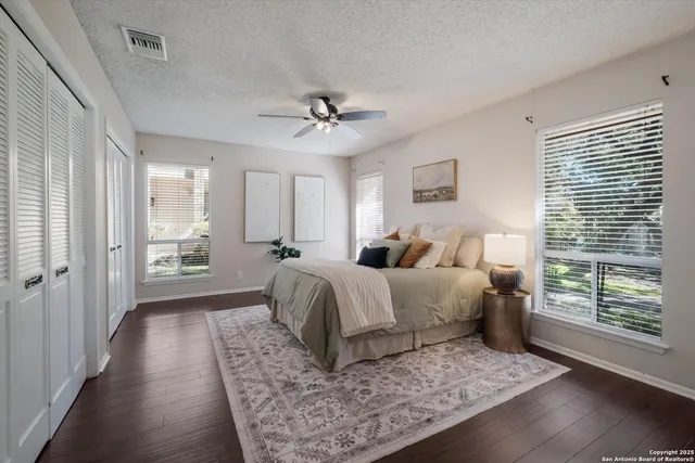 a spacious bedroom with a bed and a window
