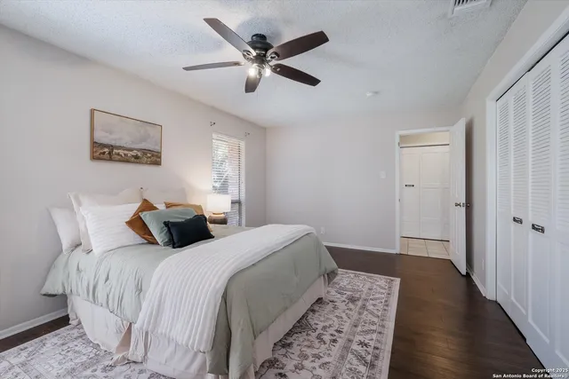 a bedroom with a large bed and a window