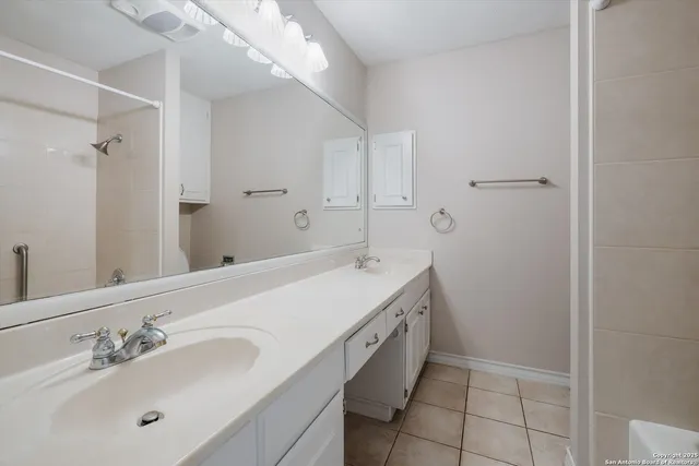 a spacious bathroom with a bathtub sink and mirror