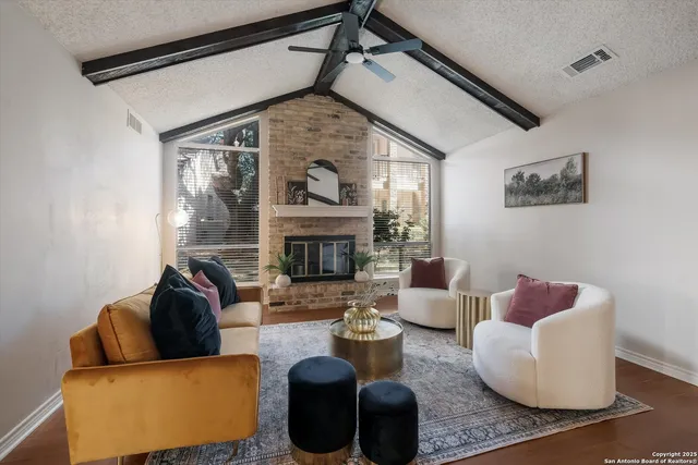 a living room with furniture and a fireplace