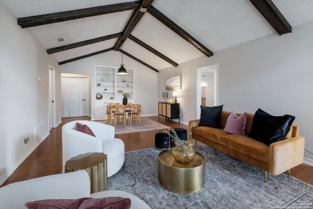 a living room with furniture and a potted plant