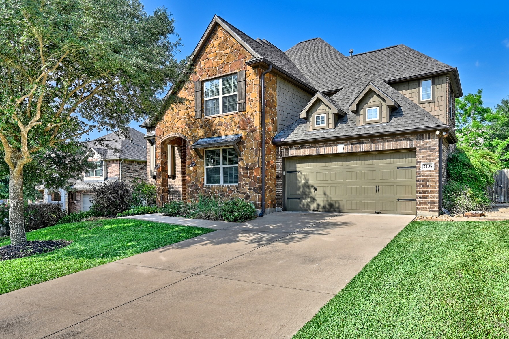 2205 Ralston Creek Court Brenham, TX 77833 - Photo 1 of 37 a view of a big house with a big yard and large trees