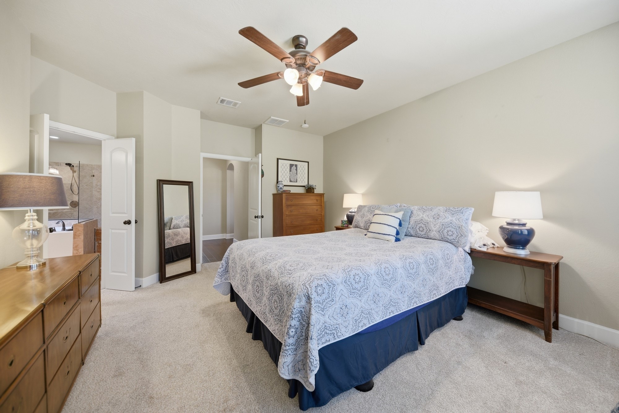 2205 Ralston Creek Court Brenham, TX 77833 - Photo 17 of 37 a spacious bedroom with a bed and ceiling fan