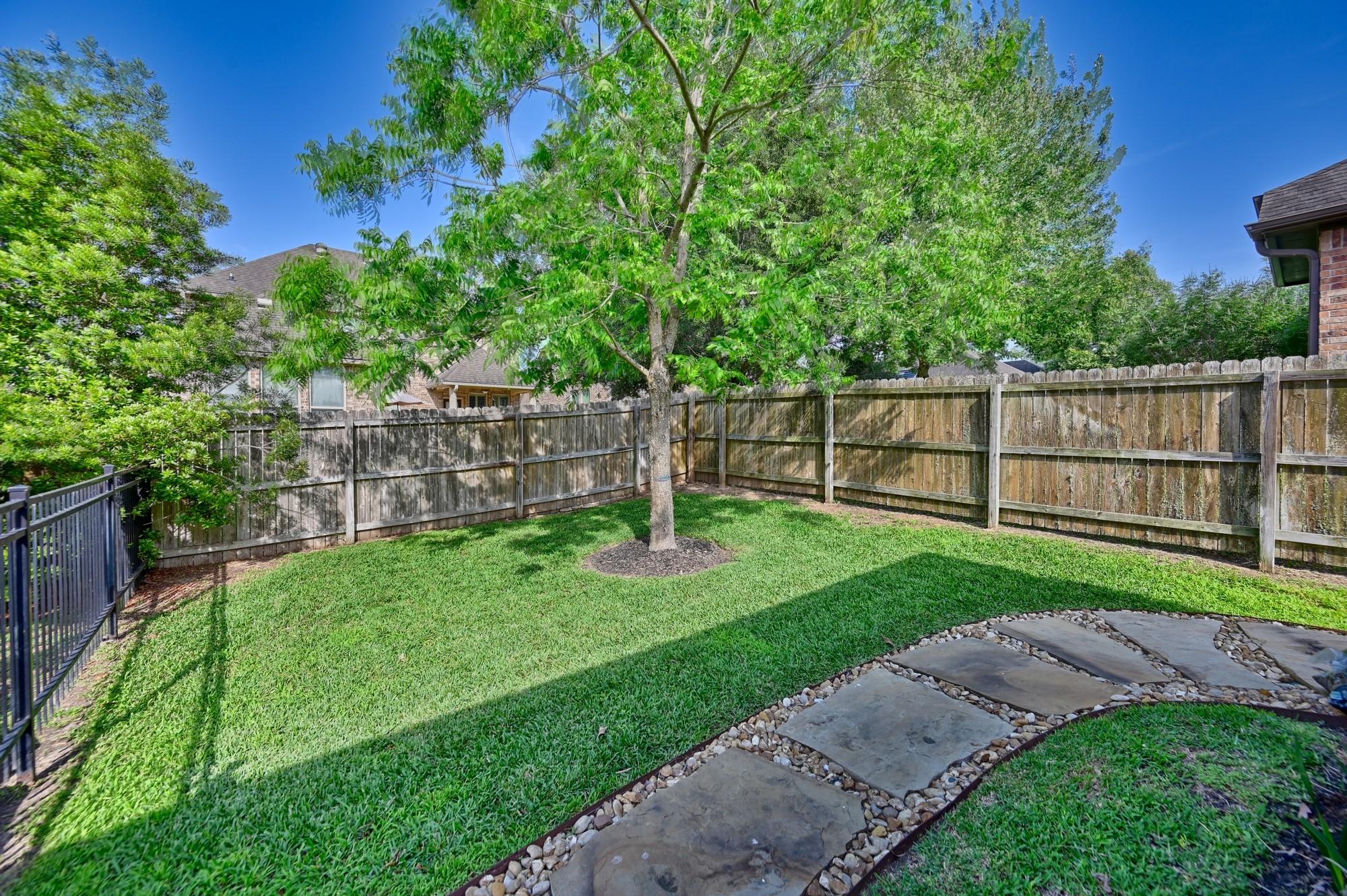 2205 Ralston Creek Court Brenham, TX 77833 - Photo 21 of 37 a view of a yard with a wooden fence