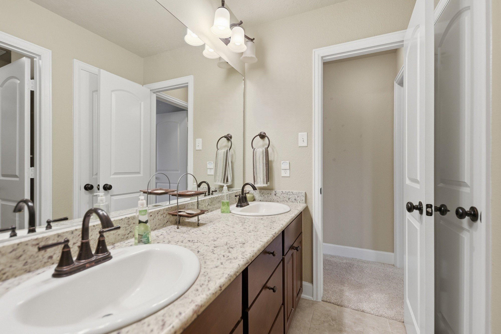 2205 Ralston Creek Court Brenham, TX 77833 - Photo 33 of 37 a bathroom with double vanity sinks a vanity and a mirror