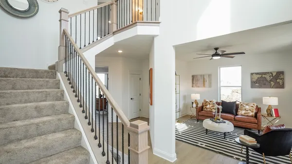 a living room with furniture and a stairs