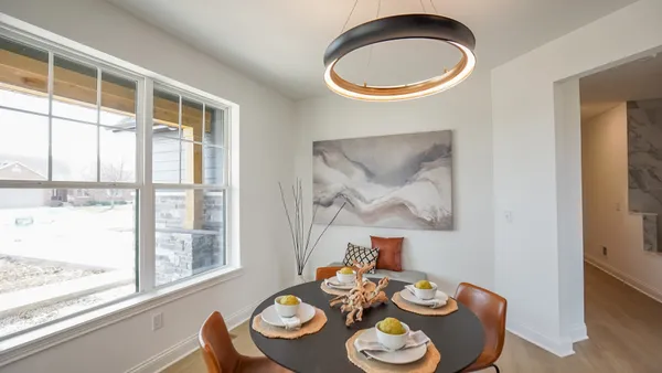 a dining room with furniture and a window
