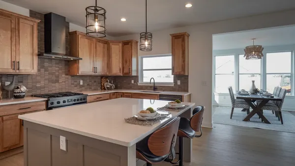 a kitchen with a table chairs stove and microwave