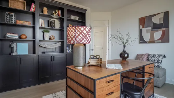 a view of a workspace with furniture and cabinet