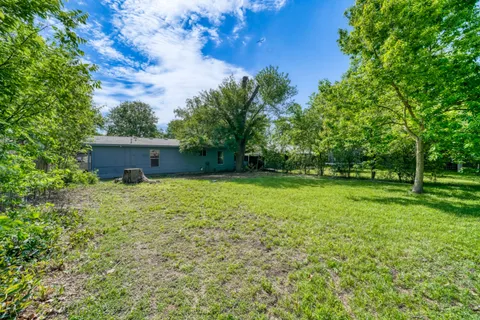 a view of a house with yard and tree s