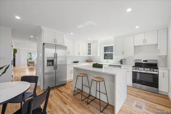 a kitchen with a table chairs refrigerator and cabinets