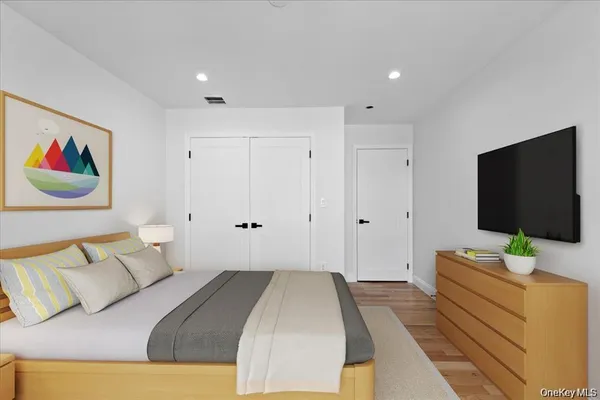 a bedroom with a bed and a flat screen tv