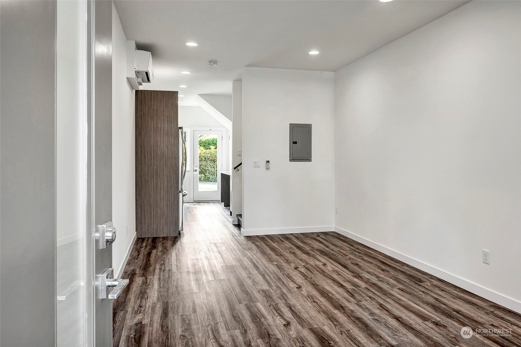 10170 Holman Road Northwest, Unit E Seattle, WA 98133 - Photo 4 of 12 a view of hallway with stainless steel appliances wooden floor and a window