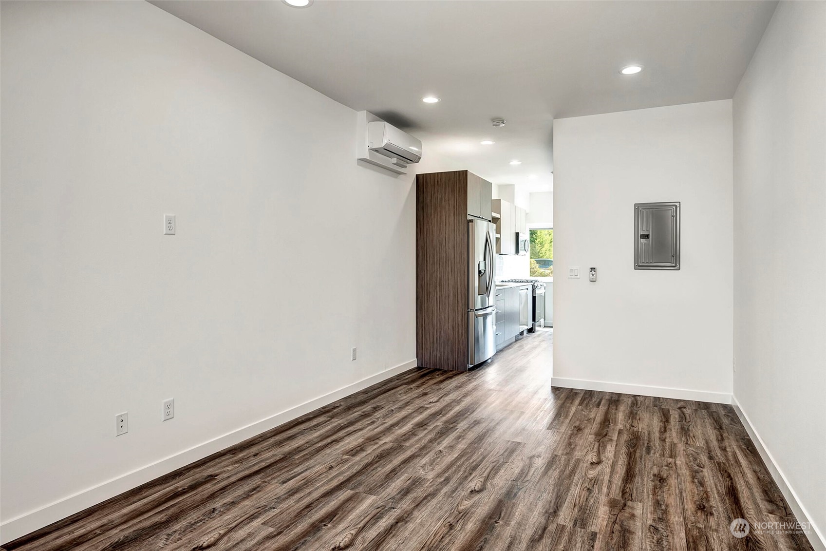 10170 Holman Road Northwest, Unit E Seattle, WA 98133 - Photo 5 of 12 a view of wooden floor in an empty room