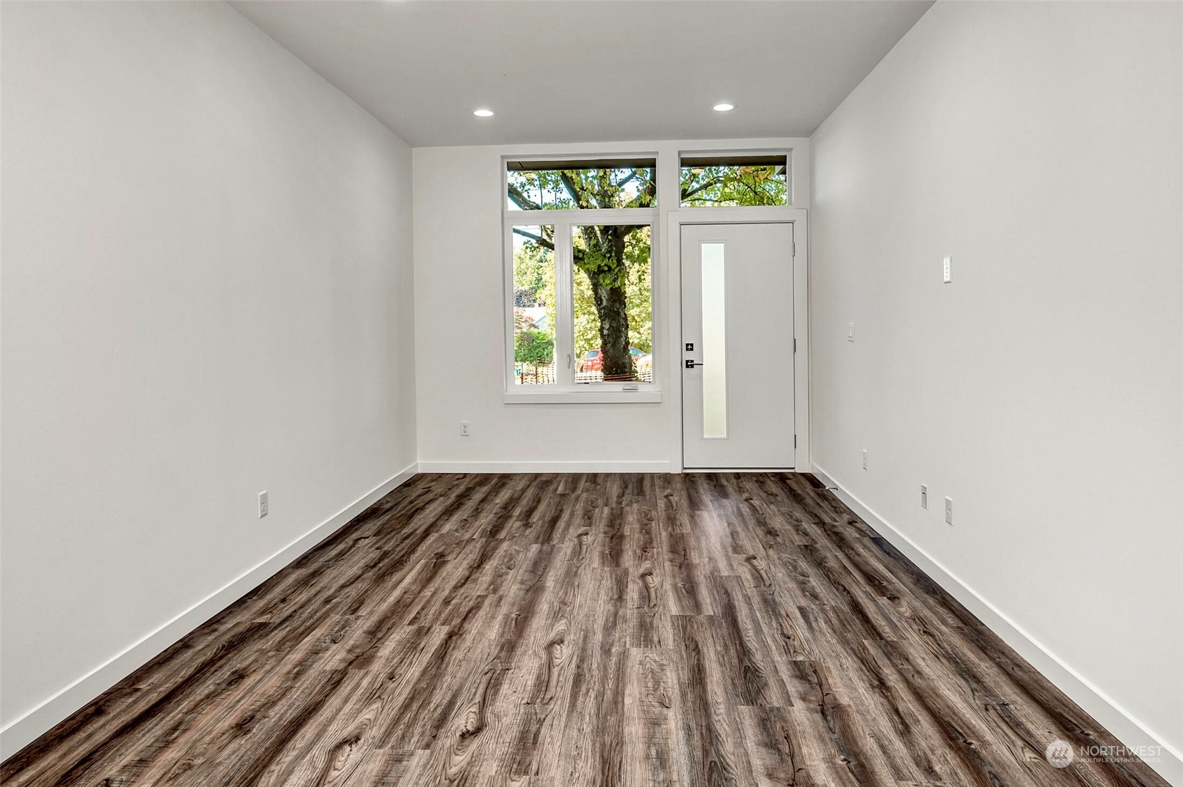 10170 Holman Road Northwest, Unit E Seattle, WA 98133 - Photo 6 of 12 a view of an empty room with a window