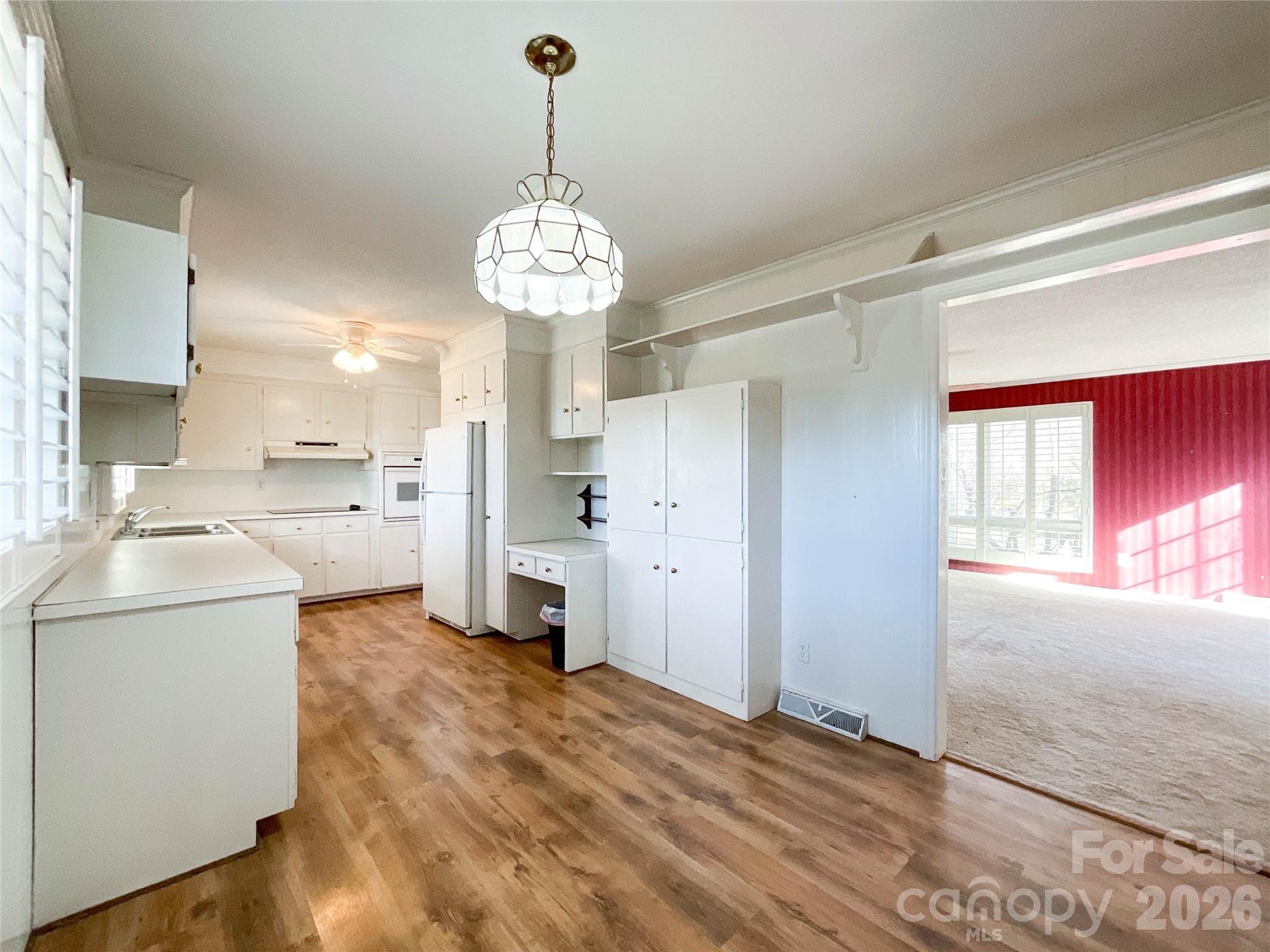 13909 Idlewild Road Matthews, NC 28105 - Photo 14 of 48 a view of a kitchen and a sink dishwasher a refrigerator with wooden floor