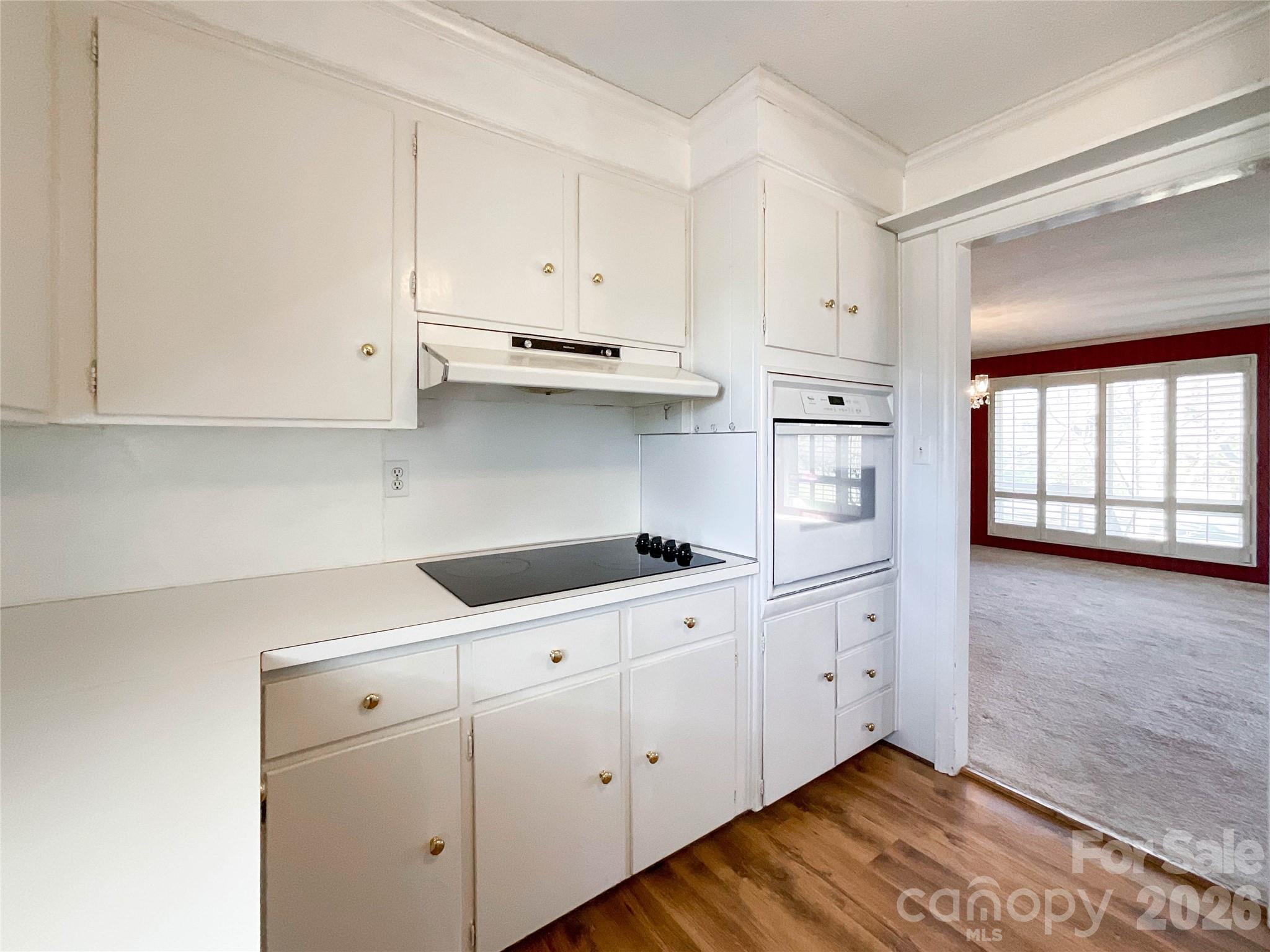 13909 Idlewild Road Matthews, NC 28105 - Photo 16 of 48 a kitchen with white cabinets and white appliances