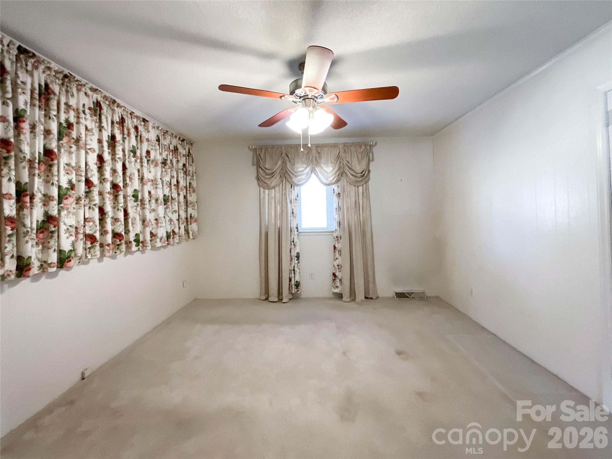 13909 Idlewild Road Matthews, NC 28105 - Photo 23 of 48 an empty room with windows and fan