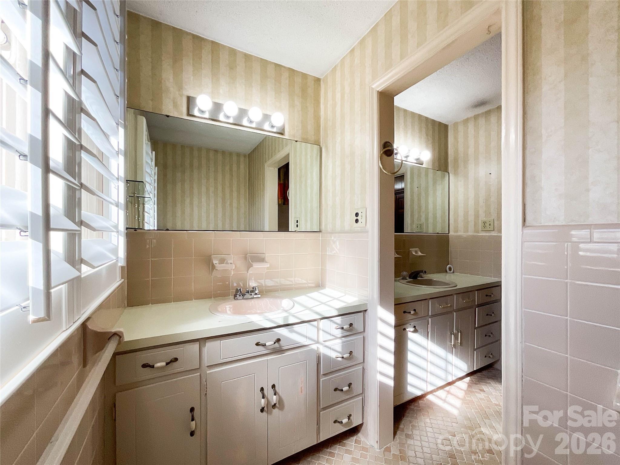 13909 Idlewild Road Matthews, NC 28105 - Photo 28 of 48 a bathroom with a sink a mirror and a shower